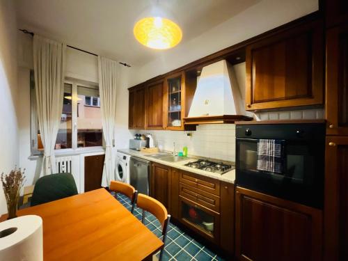 a kitchen with wooden cabinets and a wooden table at Bilocale Golf One Bedroom & Living Room with Sofa Bed in Rapallo