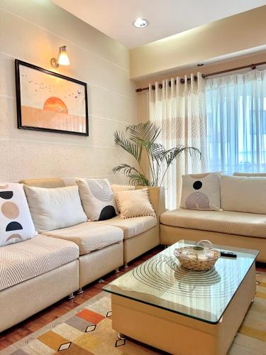 a living room with two couches and a coffee table at Cozykeyz 2BHK apartment with balconies near swayambhu in Katmandu International