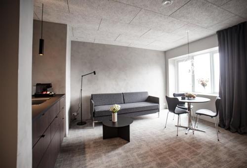 a living room with a couch and a table at Hotel Djurhuus in Tórshavn