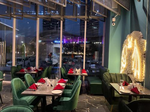 a restaurant with tables and chairs with red napkins at Sky Heights Designer Apartments-Centaurus View in Islamabad