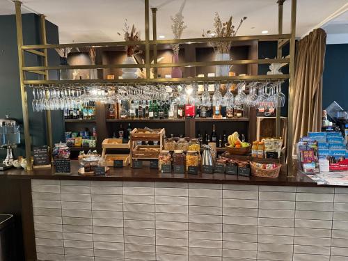 a bar in a restaurant with a lot of alcohol at Heeton Concept Aparthotel Edinburgh Queen Street in Edinburgh