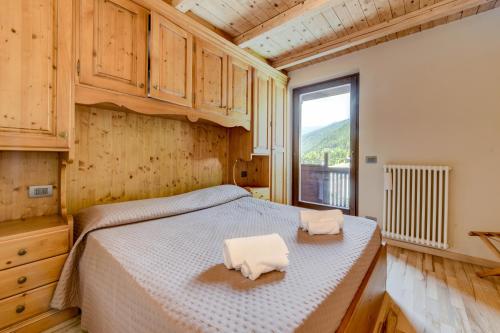 a bedroom with a bed with two towels on it at Albergo Locanda Mezzosoldo in Mortaso
