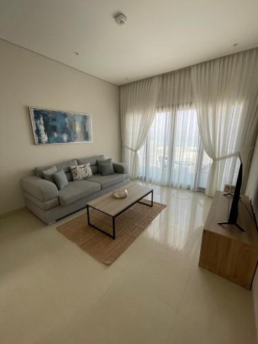 a living room with a couch and a coffee table at Sunrise Haven in As Sīfah