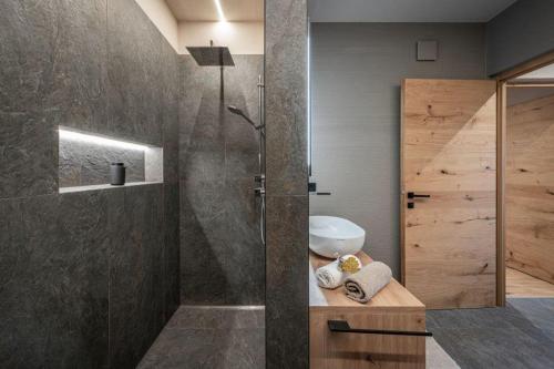 a bathroom with a shower with a toilet and a sink at Niederhof - Urlaub auf dem Bauernhof in Brixen