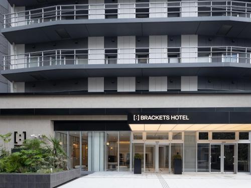 a building with a sign that reads embassy hotel at Brackets Hotel Osaka Hommachi in Osaka
