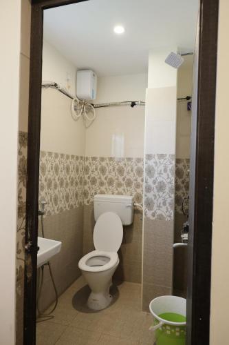 a bathroom with a toilet and a sink at Serene Stays in Chennai