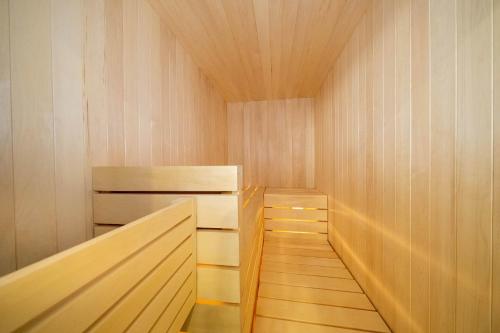 a sauna with wooden cabinets and a wooden floor at Sauna & Pool Table - Nordik Attitude in Saint-Philémon