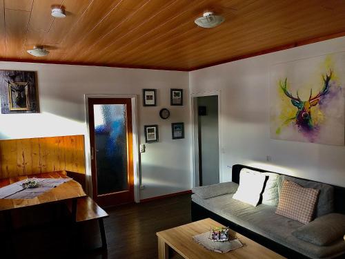 a living room with a couch and a table at Apartment Alpenstille Flattnitz in Flattnitz