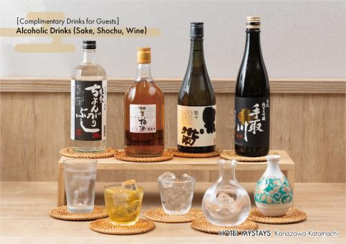 a group of wine bottles and glasses on a table at HOTEL MYSTAYS Kanazawa Katamachi in Kanazawa