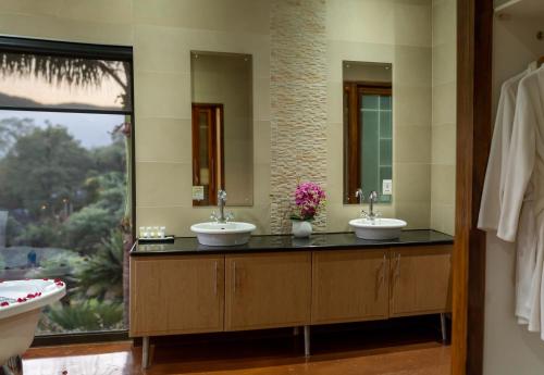 a bathroom with two sinks and a large window at Schimper View Boutique Guest House in Louis Trichardt