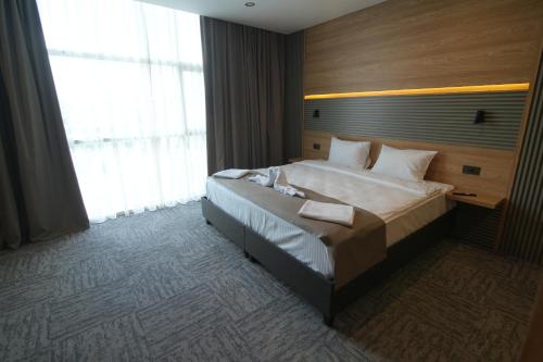 a bedroom with a large bed and a large window at Kent Room Hotel in Kapaklı