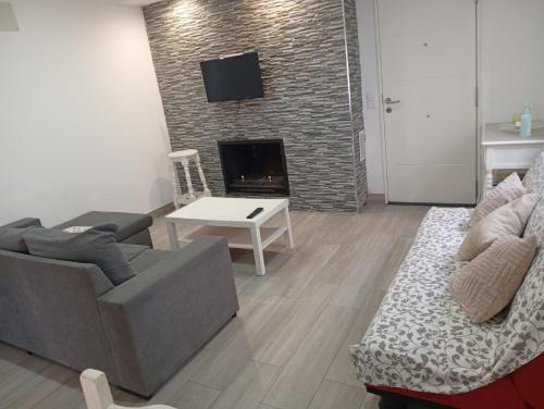 a living room with a couch and a fireplace at El Recuerdo in Arcos de la Frontera