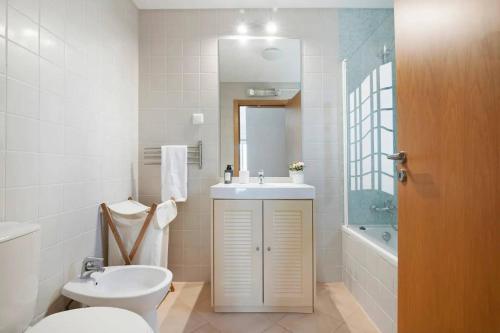 Un baño con lavabo, inodoro y bañera. en Clos des Lyces, en Santa Luzia