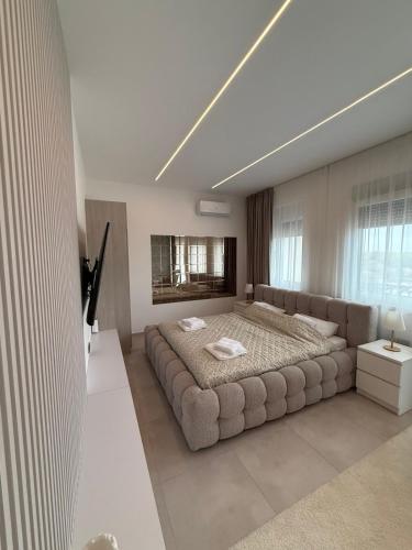 a bedroom with a large bed in a room at Raj in Subotica