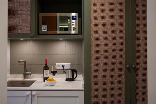 a kitchen with a counter with a sink and a microwave at HUB Apartments St Georg in Hamburg