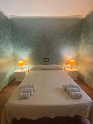 a bedroom with a bed with two towels on it at B&B Le Camelie in Nettuno
