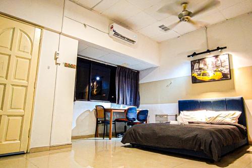 a bedroom with a bed and a table and chairs at Traditional Cottage at Sunway by HCK in Petaling Jaya