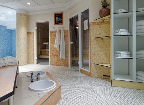 a bathroom with a sink and a shower at Hotel von Euch in Meppen
