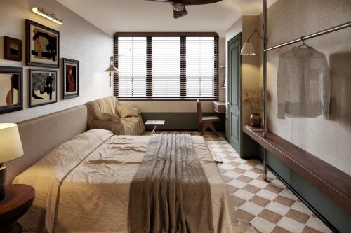 a bedroom with a bed and a chair and a window at A Stay In Bàu Vá in Hue