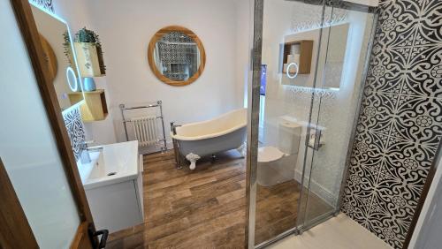 a bathroom with a bath tub and a shower at Headmasters House in Port Isaac