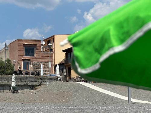 a green object in front of a building at Terrazza sul mare a Nizza di Sicilia in Nizza di Sicilia