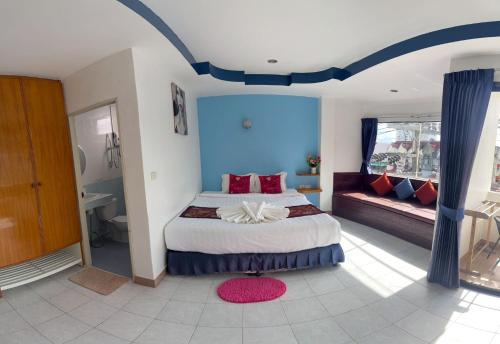 a bedroom with a large bed and a couch at Heaven House Restro & Bar in Patong Beach