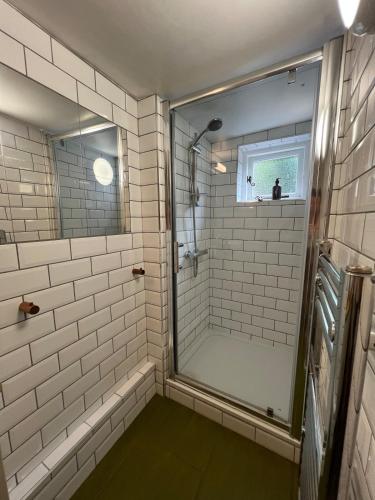 a bathroom with a shower with a glass door at The Sandwich Hideaway in Sandwich
