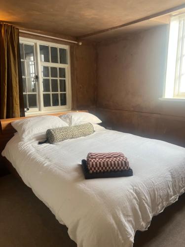 a large white bed with two pillows on it at The Sandwich Hideaway in Sandwich