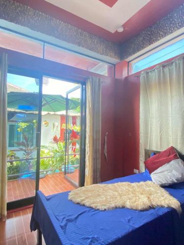 a bedroom with a large bed with an aquarium in the background at Pirate Galeon Resort in Carcar