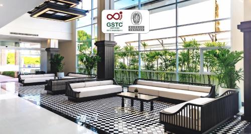 a lobby with couches and tables in a building at Best Western Chaweng Samui in Chaweng