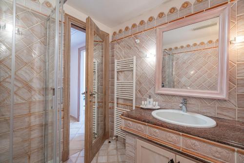 a bathroom with a sink and a shower at Petra Bianca in Porto Cervo