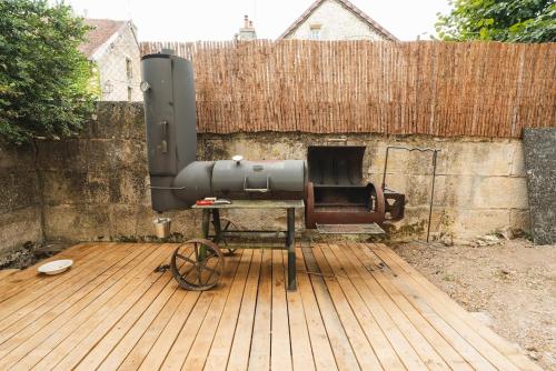 a cannon sitting on a wooden deck next to a fence at Maison Michaut in Aignay-le-Duc