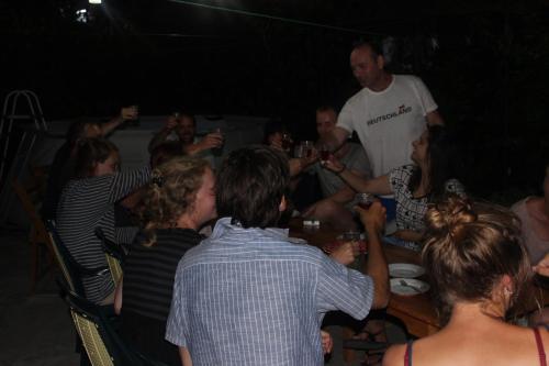 a group of people sitting around a table with a man at Giorgi's Homestay in Kutaisi