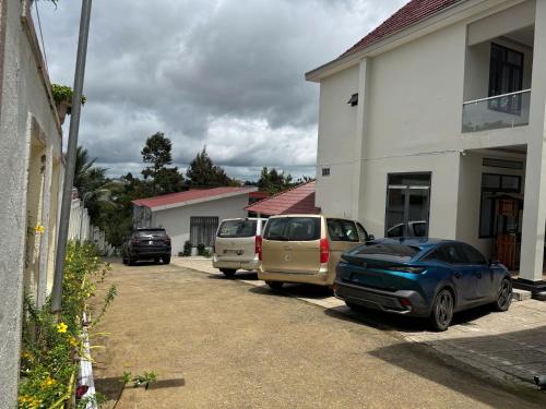 a group of cars parked in a driveway next to a building at Homestay Nam Anh in Bảo Lâm