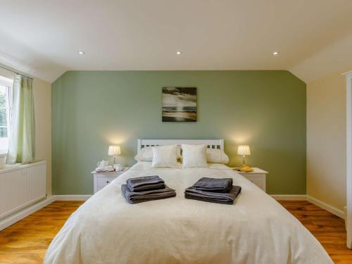 a bedroom with a large bed with two towels on it at 1 bed in Cinderford 88272 in Cinderford
