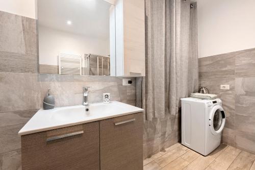 a bathroom with a sink and a washing machine at La Casa Di Beppe - Val d'Intelvi in Lanzo dʼIntelvi