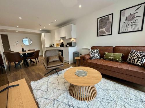 a living room with a couch and a table at Luxury 2 bed Apartment Bracknell in Bracknell