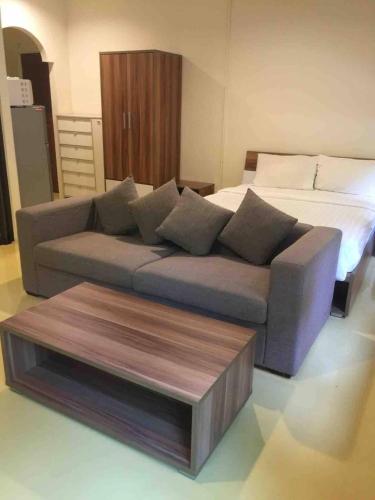 a living room with a couch and a bed at Nakara Samui S4 Two Bedrooms Apt in Ban Thong Phlu