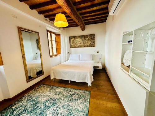 a bedroom with a bed and a mirror at TRUFFLE'N'BED in San Giovanni dʼAsso