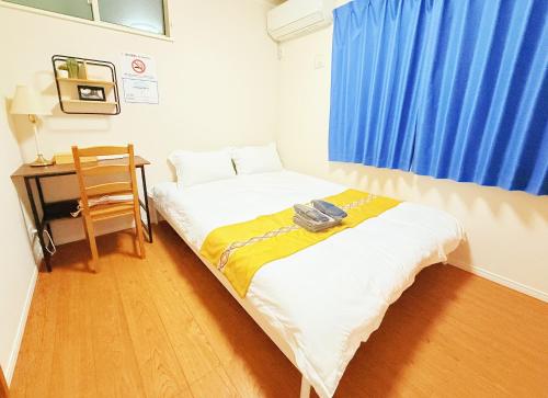 Ένα ή περισσότερα κρεβάτια σε δωμάτιο στο 池袋本町202