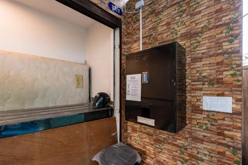 a door in a room with a brick wall at The Hidden Sao Chingcha in Bangkok