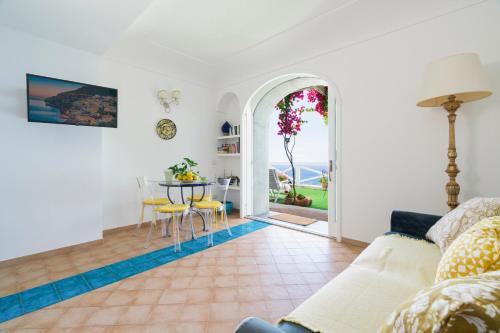 a living room with a table and a dining room at Calante Luna in Praiano