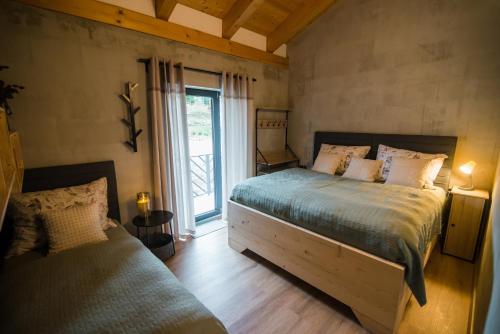 a bedroom with a large bed and a window at Chalet OSHI Jasna in Belá