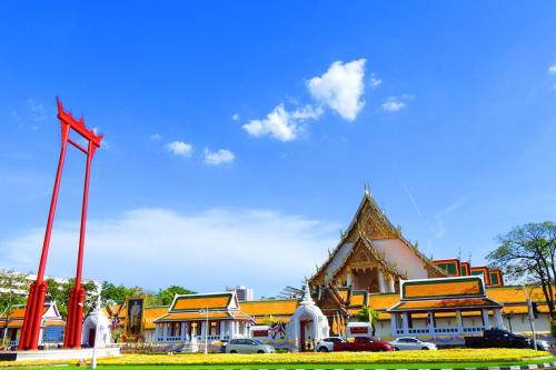 a large building with a red flag in front of it at The Hidden Sao Chingcha in Bangkok