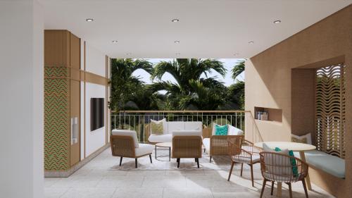 een patio met stoelen, een bank en een tafel bij Maraleina Sports Resort in Nathon Bay