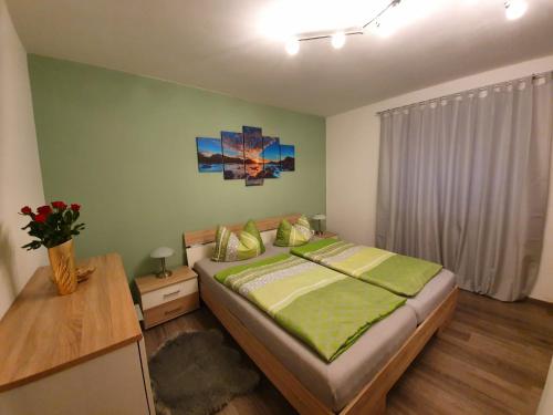 a bedroom with a large bed and a table at Ferienwohnung Yvonne in Freyung