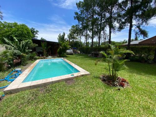 a swimming pool in the yard of a house at Casaquinta grande con pileta y parrilla in Camba Punta