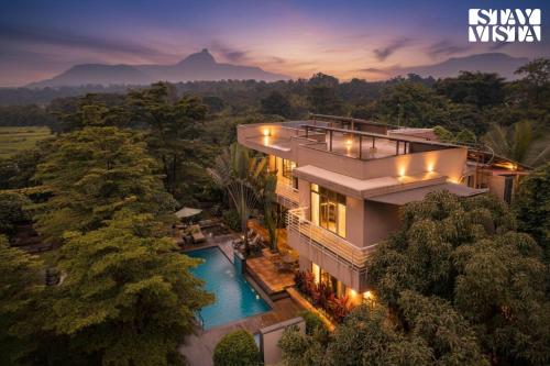 an aerial view of a house with a swimming pool at StayVista at Belmonte with Bonfire, Jacuzzi in Karjat
