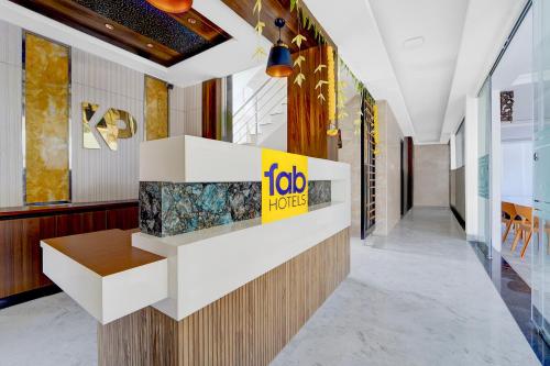a lobby with a job horizons sign on the wall at FabHotel Kayal Plaza in Coimbatore