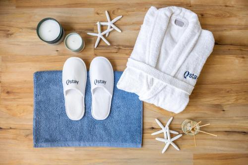 a pair of shoes and a towel and a pair of socks at Ultra Luxury Palm - Free 5-star Beach Resorts Access in Dubai